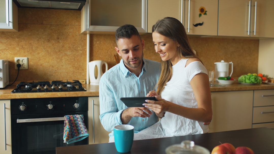 Couple looking at tablet in modern kitchen