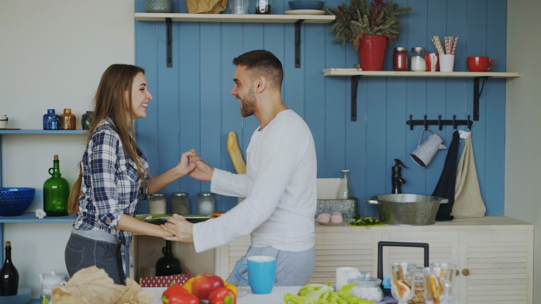 Couple dancing together in a bright kitchen