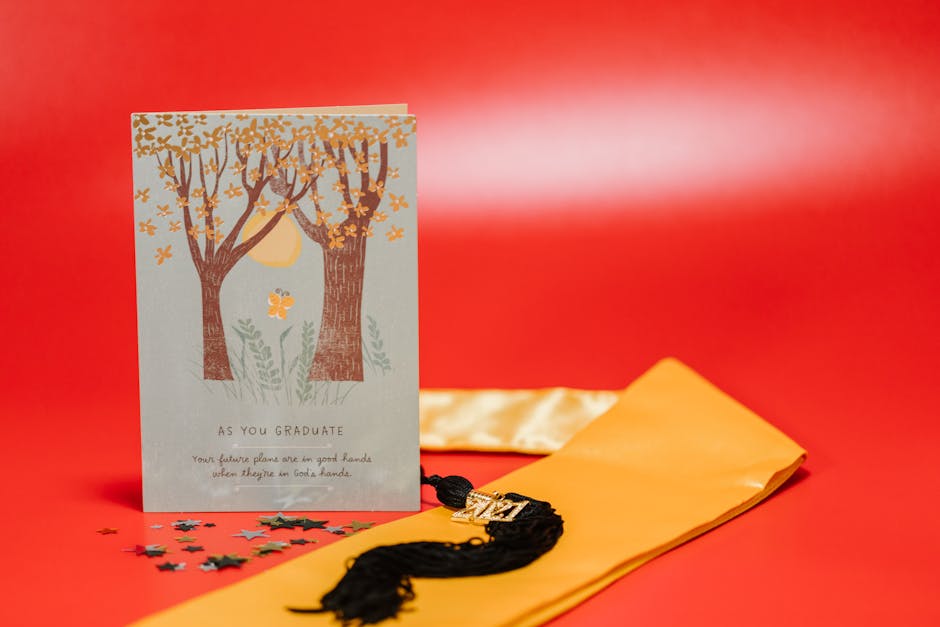 Graduation card and tassel on a vibrant red background with star confetti.