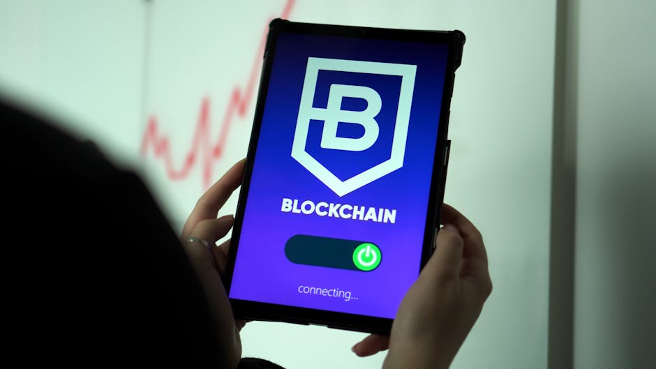 Close-up of hands holding a tablet displaying a blockchain application interface.