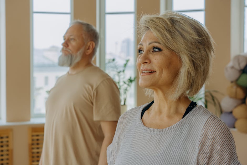 Senior couple at a wellness studio enjoying yoga and relaxation indoors.