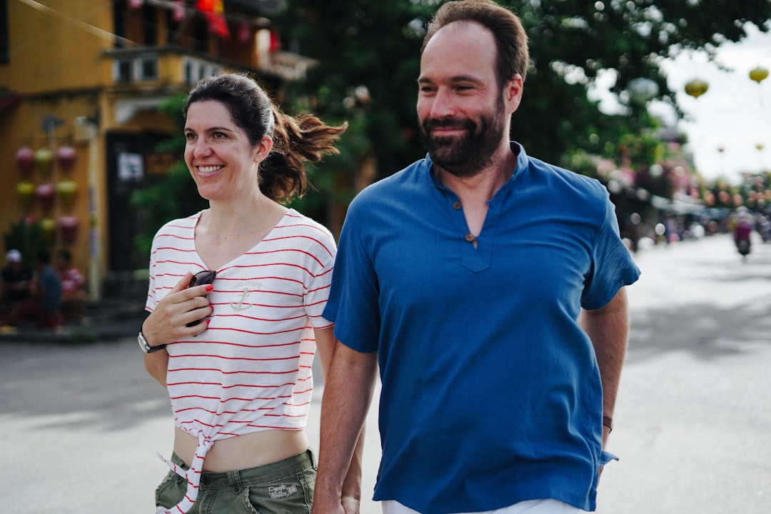A couple walking hand in hand down a street