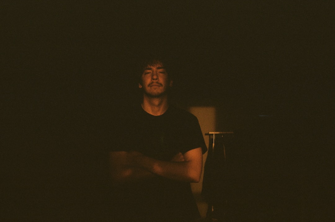 A man sitting on a stool in the dark