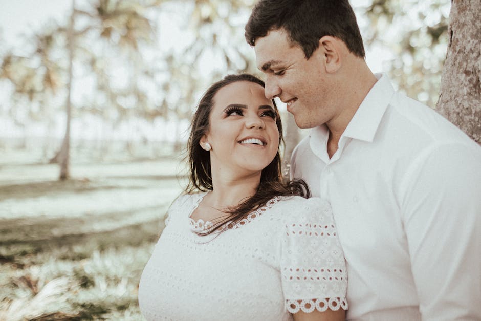 A joyful couple sharing a moment of love in a sunny tropical paradise.