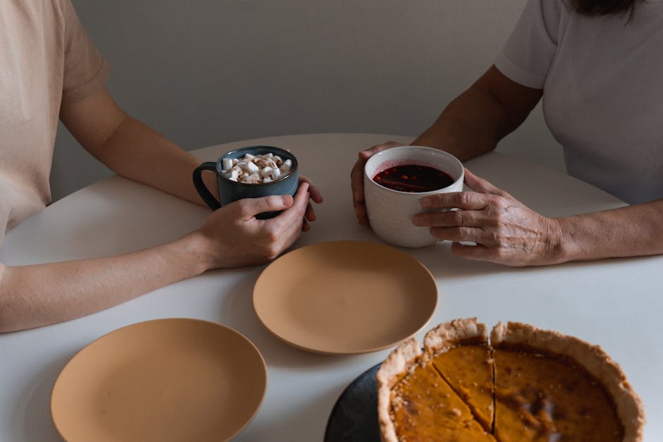Two people enjoying coffee and pie, creating a cozy and warm atmosphere.