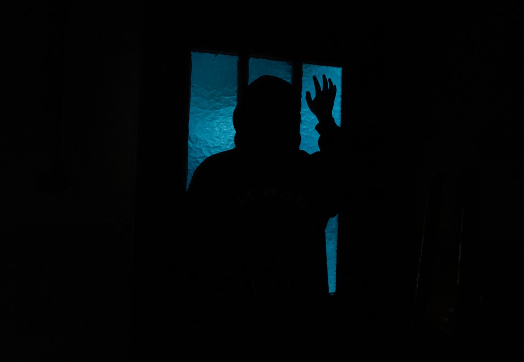a silhouette of a person in a dark room