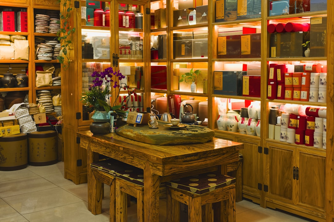 Wooden shelves filled with tea boxes and jars.