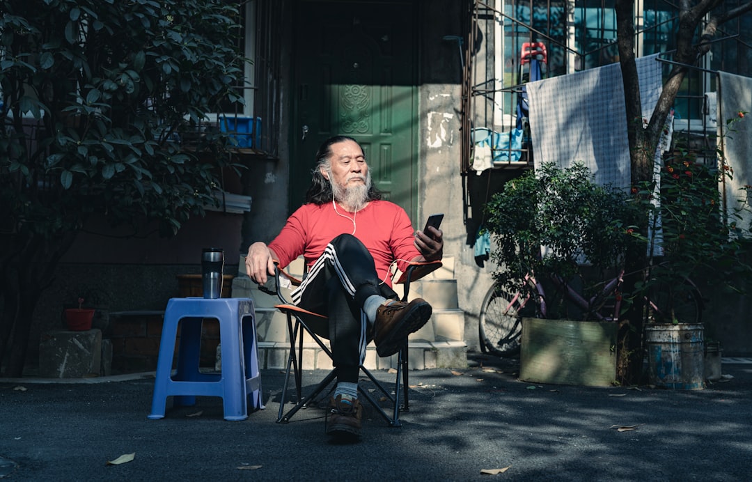 man in red jacket sitting on chair