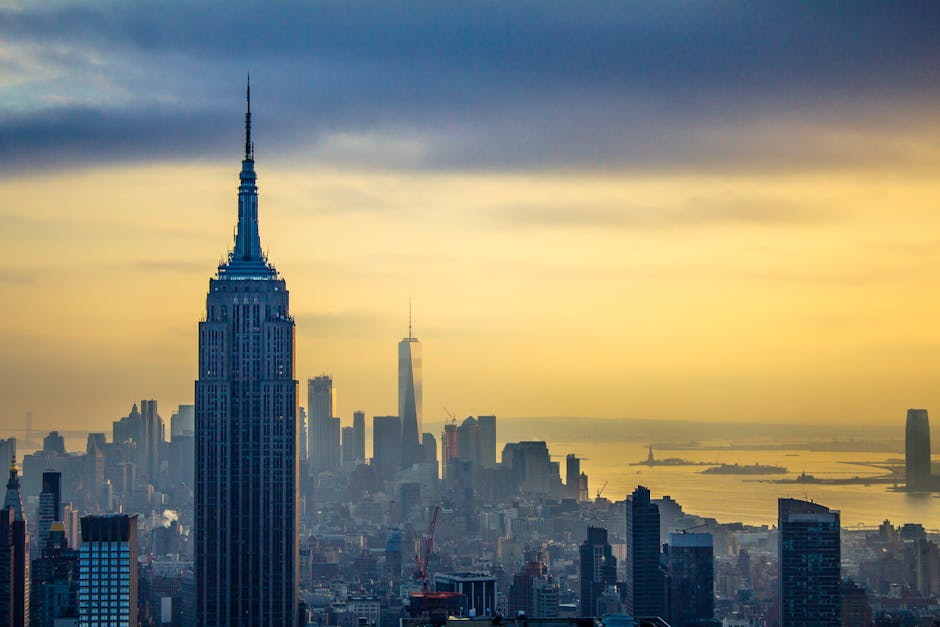 A stunning aerial view of the New York City skyline featuring the Empire State Building at dawn.