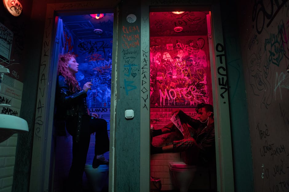 Punk-inspired image of individuals in vibrant, graffiti-covered restrooms, exuding rebellious energy.